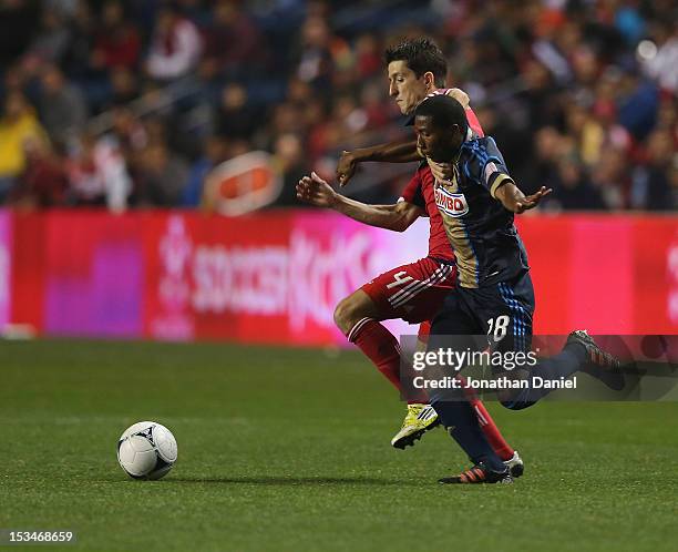 Alvaro Fernandez of the Chicago Fire and Raymon Gaddis of the Philadelphia Union battle for the ball during an MLS match at Toyota Park on October 3,...