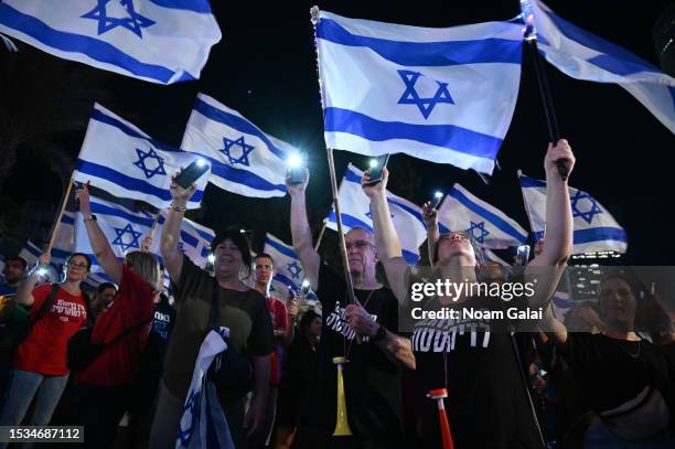 Protesters attend a demonstration on Kaplan Street against the Israeli government’s plan to overhaul the justice system on July 11, 2023 in Tel Aviv,...
