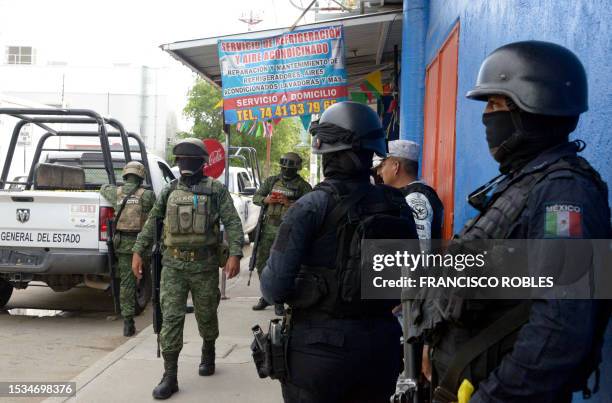 Mexican Army soldiers and members of the State Police check the area where Mexican journalist Nelson Matus was murdered in the resort town of...