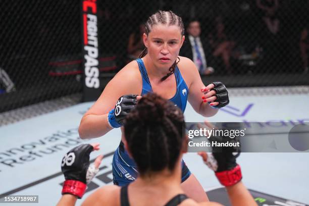 In this handout image provided by UFC, Chelsea Chandler battles Norma Dumont of Brazil in their featherweight fight during the UFC Fight Night at UFC...