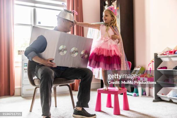 grandfather and granddaughter dressing up in homemade costumes at home - fancy dress costume imagens e fotografias de stock