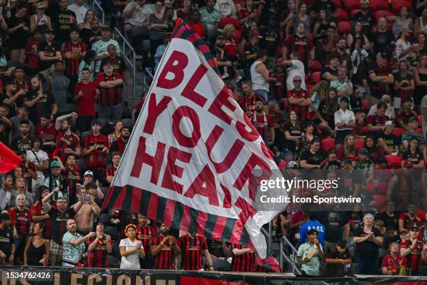 Atlanta fans wave a flag during the MLS match between Orlando City SC and Atlanta United FC on July 15th, 2023 at Mercedes-Benz Stadium in Atlanta,...