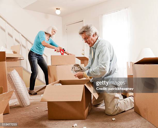 senior couple moving - senior moving house stock pictures, royalty-free photos & images