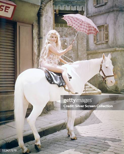 Toni Vincente, played by Italian actress Gina Lollobrigida, naked on horseback in 'Strange Bedfellows', directed by Melvin Frank, 1965.