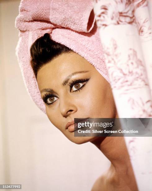 Italian actress Sophia Loren with her hair wrapped in a towel, in 'Arabesque', directed by Stanley Donen, 1966.