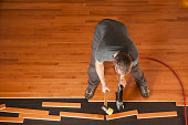 Man installing a wood floor shown from above