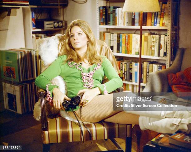 American actress Barbra Streisand, in a mini dress and white boots, as Doris in 'The Owl And The Pussycat', directed by Herbert Ross, 1970.