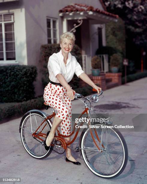 American actress Doris Day riding a Schwinn bicycle, circa 1955.