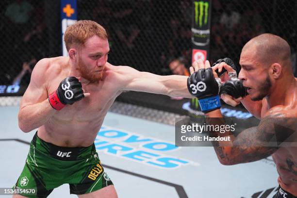 In this handout image provided by UFC, Jack Della Maddalena of Australia punches Bassil Hafez in their welterweight fight during the UFC Fight Night...