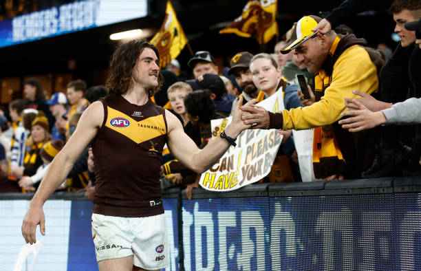 Jai Newcombe of the Hawks celebrates with fans during the 2023 AFL Round 18 match between the North Melbourne Kangaroos and the Hawthorn Hawks at...