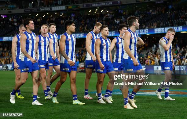 Kangaroos players look dejected after a loss during the 2023 AFL Round 18 match between the North Melbourne Kangaroos and the Hawthorn Hawks at...