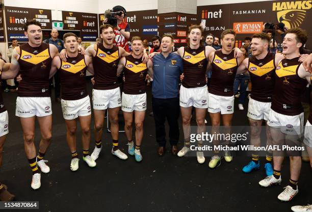 The Hawks sing the team song during the 2023 AFL Round 18 match between the North Melbourne Kangaroos and the Hawthorn Hawks at Marvel Stadium on...