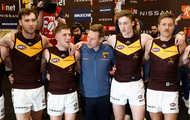 Sam Mitchell, Senior Coach of the Hawks sings the team song with is players during the 2023 AFL Round 18 match between the North Melbourne Kangaroos...