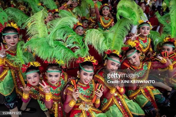 Dancers pose for photographs during the Surabaya Cross Culture International Folk Art Festival in Surabaya on July 16, 2023.