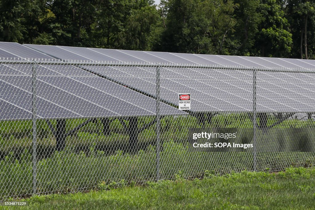 Array Part Ten Part of a ten acre solar panel array is seen behind a fence on the ...