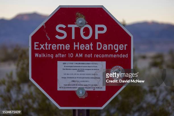 Sign warns of extreme heat danger on the eve of a day that could set a new world heat record in Death Valley National Park on July 15, 2023 near...
