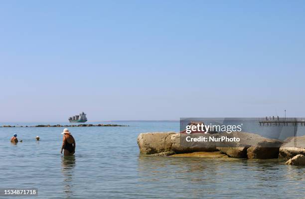 Man sunbathes on the rocks on a public beach on a hot summer day in the Mediterranean port of Limassol. Cyprus, Friday, July 14, 2023. The...
