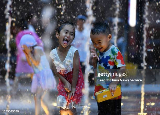 Children play in a fountain to cool off during high temperatures on July 11, 2023 in Shijiazhuang, Hebei Province of China.