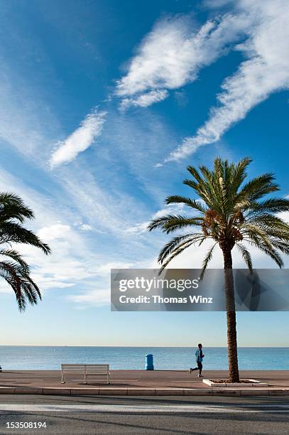 jogger along "quai des etats-unis" - cote dazur stock pictures, royalty-free photos & images