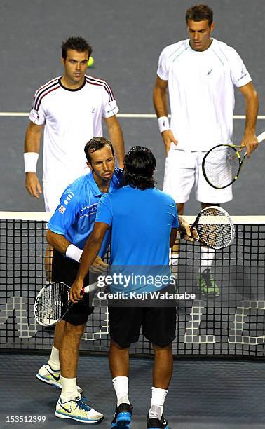 Radek Stepanek of the Czech Republic and Leander Paes of India stand at the net after their semi final doubles match against Daniele Bracciali of...