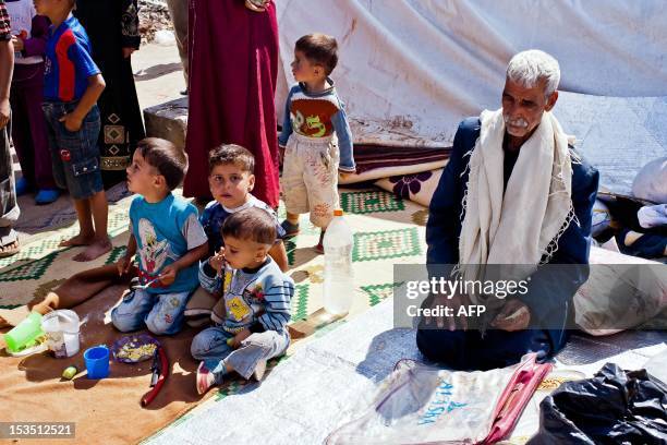 Syrians refugees are seen in a camp near the northern town of Azaz, on the border with Turkey, on October 5, 2012. Damascus' bloody crackdown on the...