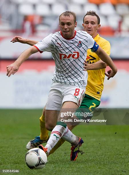 Denis Glushakov of FC Lokomotiv Moscow battles for the ball with Aleksei Kozlov of FC Kuban Krasnodar during the Russian Premier League match between...