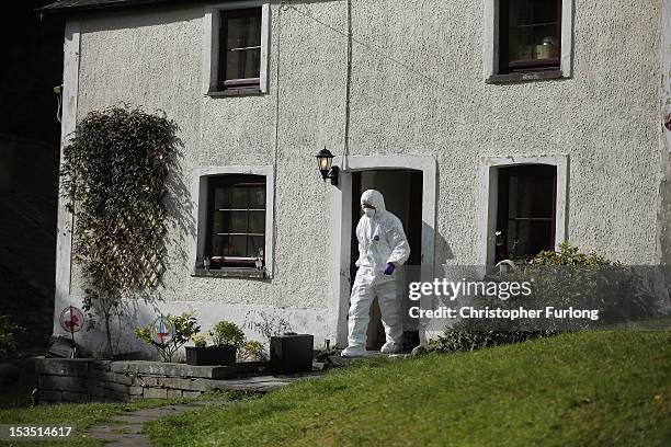 Police forensic scientists search the house of Mark Bridger in the village of Ceinws as the hunt for missing April Jones continues on October 6, 2012...