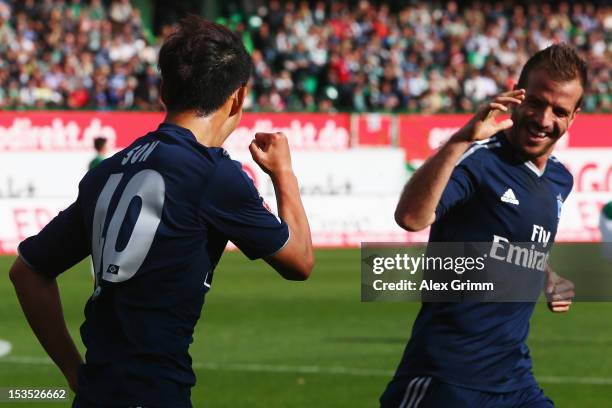 Heung-Min Son of Hamburg celebrates his team's first goal with team mate Rafael van der Vaart during the Bundesliga match between SpVgg Greuther...