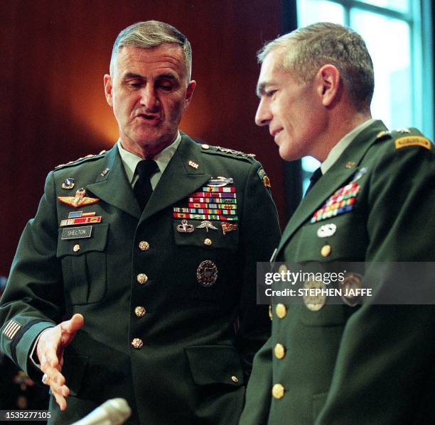 Chairman of the Joint Chiefs of Staff Army General Henry Shelton converses with General Wesley Clark , the supreme allied commander in Europe, 22...