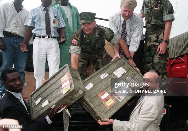 Marine Colonel Jon W. Stull , commander of US Support Group in Haiti and Mark Schlakman , a representantive of Florida governor Lawton Chiles, give...