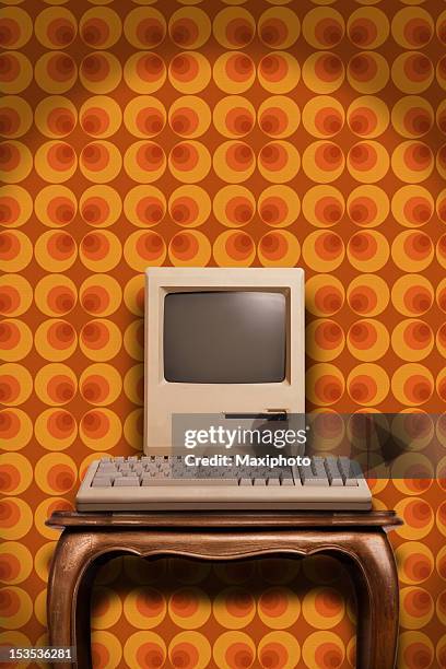 alte desktop-computer auf holztisch und siebziger jahren tapete - 70er jahre stock-fotos und bilder