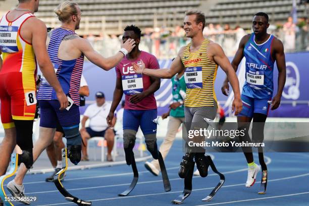 Johannes Floors of team Germany and Jonnie Peacock of team Great Britain shake hands after the race in the Men's 100m T64 during day four of the Para...