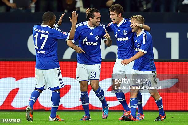 Roman Neustaedter of Schalke celebrates the third goal with Jefferson Farfan , Christian Fuchs and Lewis Holtby during the Bundesliga match between...