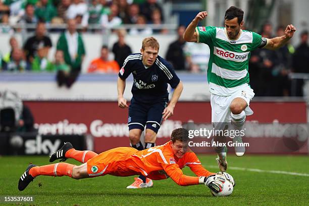 Goalkeeper Max Gruen of Greuther Fuerth makes a save ahead of team mate Mergim Mavraj and Artjoms Rudnevs of Hamburg during the Bundesliga match...