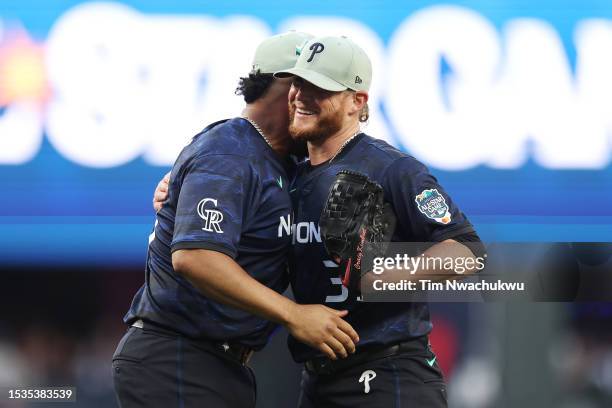 Craig Kimbrel of the Philadelphia Phillies celebrates with Elias Díaz of the Colorado Rockies after defeating the American League 3-2 during the 93rd...