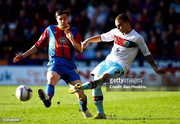 Kieran Tripper of Burnley passes under pressure from Owen Garvan of Crystal Palace during the npower Championship match between Crystal Palace and...