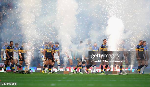 The Warrington and Leeds players walk out onto the pitch prior to the Stobart Super League Grand Final between Warrington Wolves and Leeds Rhinos at...