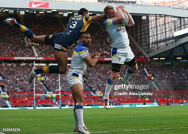 Chris Riley of Warrington Wolves beats Kallum Watkins of Leeds Rhinos to the ball during the Stobart Super League Grand Final between Warrington...