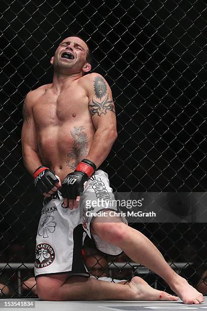 Jens Pulver of the USA reacts after being kicked in the groin by Zhao Ya Fei of China during the One Fighting Championship, Bantamweight Grand Prix...