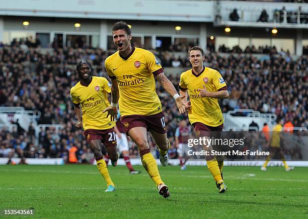 Olivier Giroud celebrares scoring for Arsenal with Gervinho and Aaron Ramsey during the Barclays Premier League match between West Ham United and...