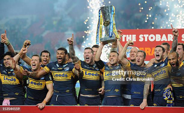 Kevin Sinfield of Leeds Rhinos lifts the trophy with his team mates following their victory at the end of the Stobart Super League Grand Final...