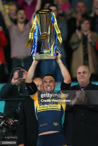 Kevin Sinfield of Leeds Rhinos lifts the trophy following his team's victory at the end of the Stobart Super League Grand Final between Warrington...