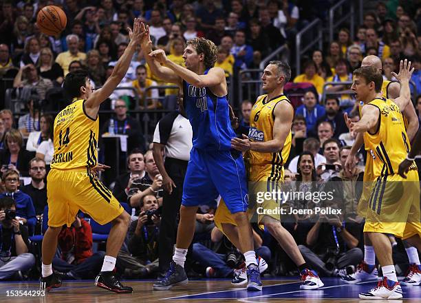 Dirk Nowitzki of Dallas is challenged by Sven Schultze and Nihad Djedovic of Berlin during the NBA Europe Live 2012 Tour match between Alba Berlin...