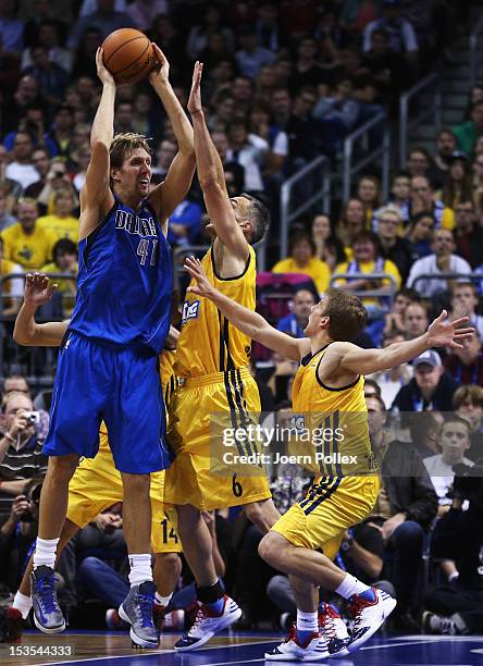 Dirk Nowitzki of Dallas is challenged by Sven Schultze and Nihad Djedovic of Berlin during the NBA Europe Live 2012 Tour match between Alba Berlin...