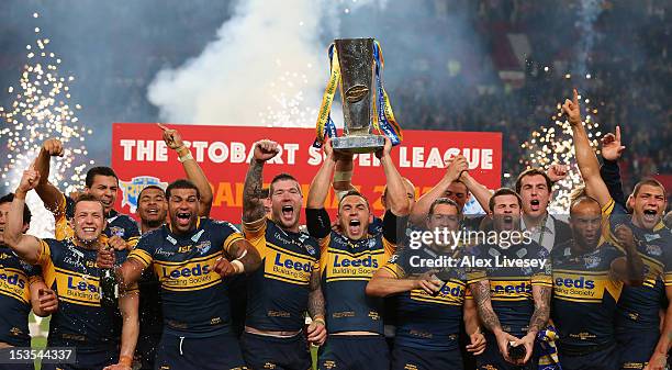 Kevin Sinfield of Leeds Rhinos lifts the trophy with his team mates following their victory at the end of the Stobart Super League Grand Final...