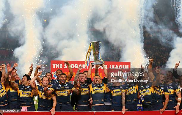 Kevin Sinfield of Leeds Rhinos lifts the trophy with his team mates following their victory at the end of the Stobart Super League Grand Final...