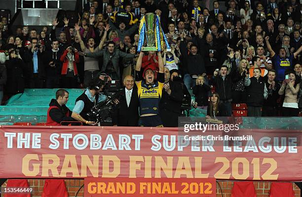 Kevin Sinfield of Leeds Rhinos lifts the trophy following his team's victory at the end of the Stobart Super League Grand Final between Warrington...