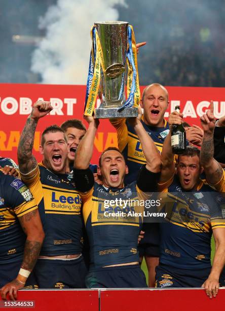 Kevin Sinfield of Leeds Rhinos lifts the trophy with his team mates following their victory at the end of the Stobart Super League Grand Final...