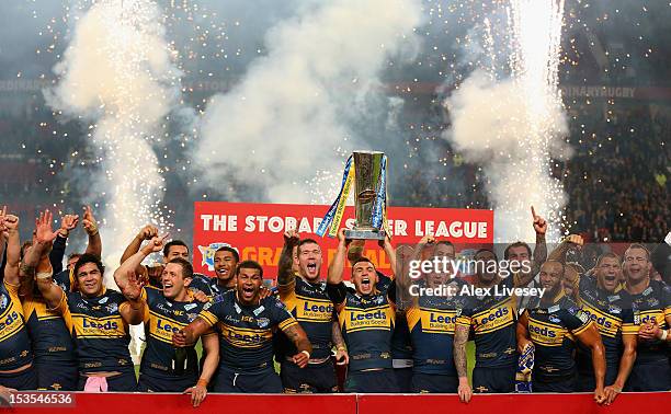 Kevin Sinfield of Leeds Rhinos lifts the trophy with his team mates following their victory at the end of the Stobart Super League Grand Final...