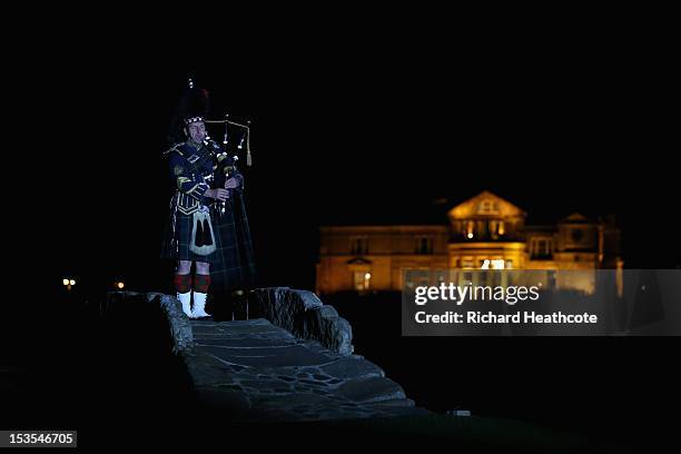 Scottish Piper plays the bagpipes on The Swilcan Bridge after the third round of the Alfred Dunhill Links Championship on The Old Course at St...